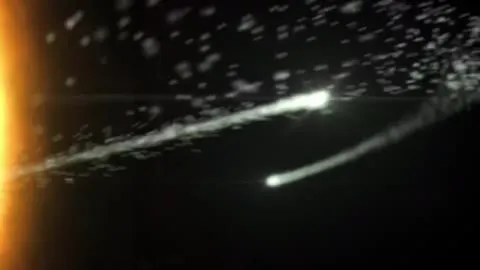 Solar particles streaming outward from a bright centre.