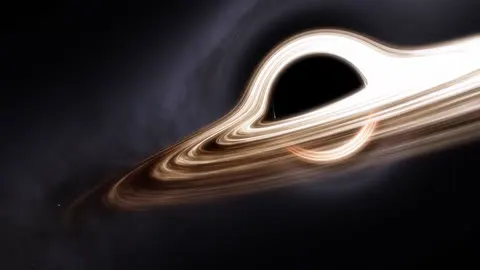 Saturn turning, its rings catching the light.