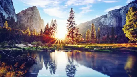 A mountain range mirrored in the lake below it.